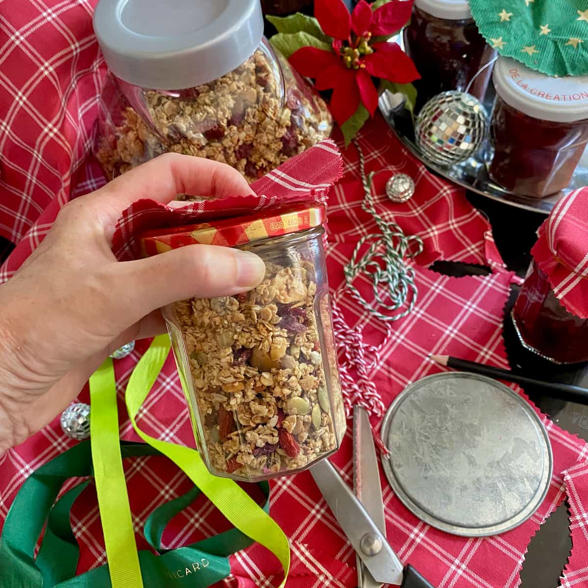 preparing jars of homemade granola for Christmas presents