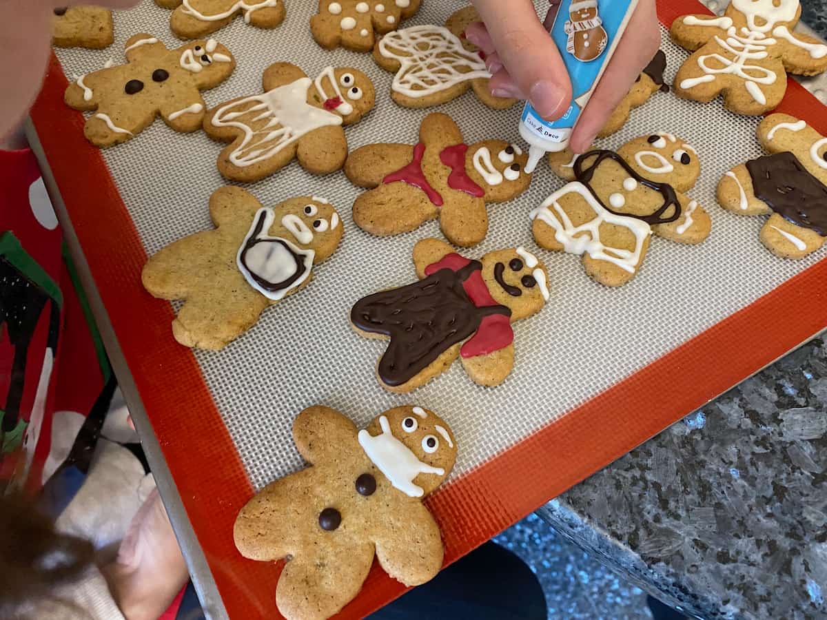 decorating gingerbread men and women with icing pens