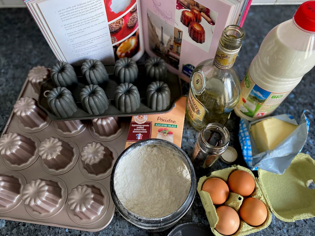 ingredients laid out with moulds to make canelés cakes