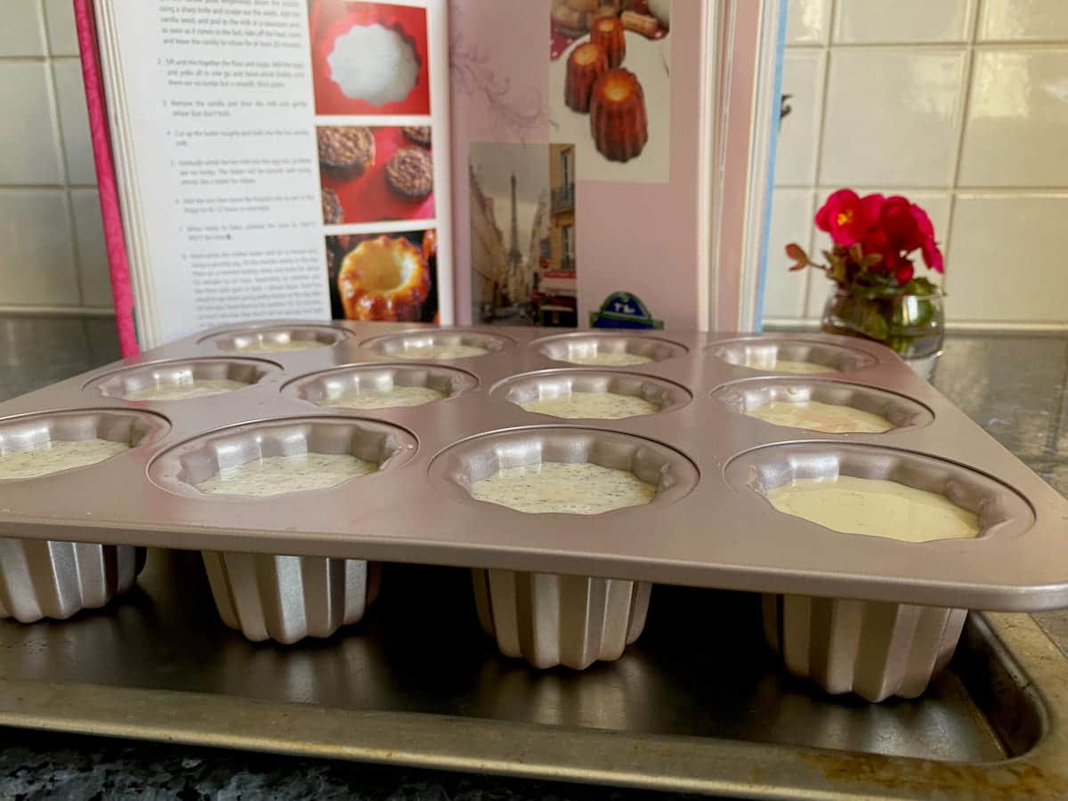 fluted cake tin filled with vanilla and rum batter on a tray