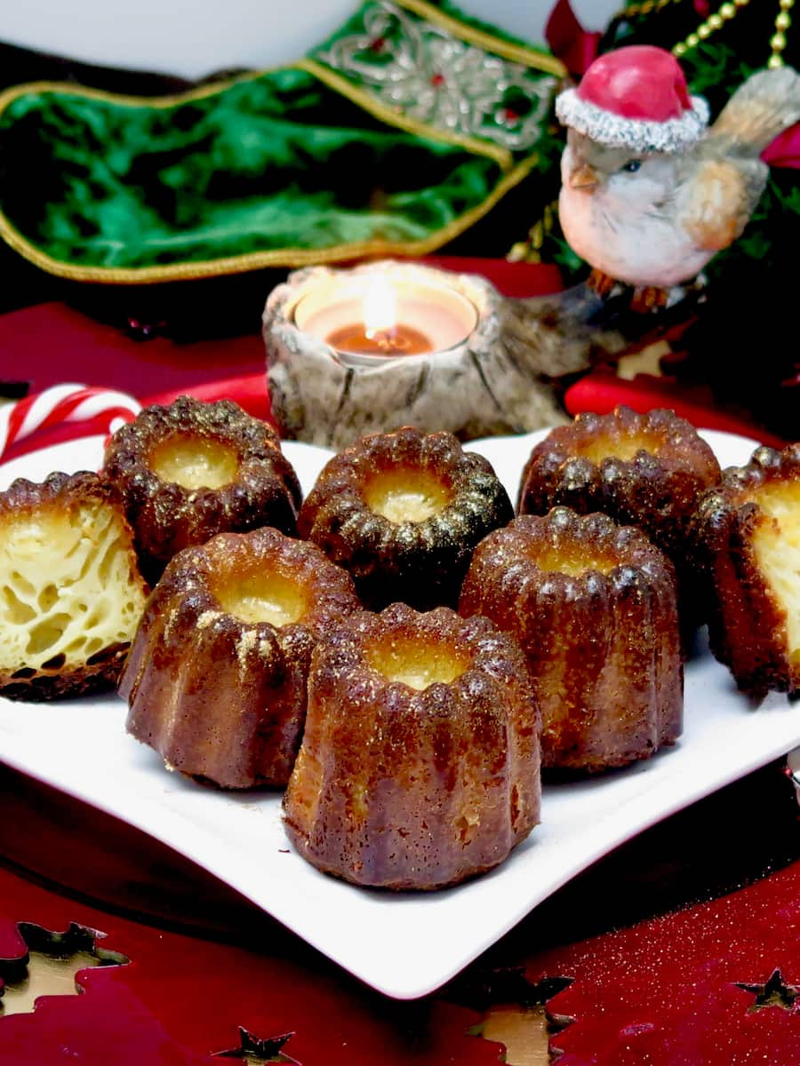 plate of fluted canelés cakes, dark and caramelised on the outside, eggy vanilla soft in the inside