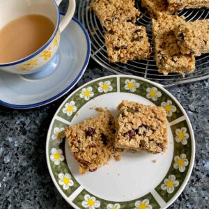 plate of square cut flapjacks made with honey, fruit and nuts