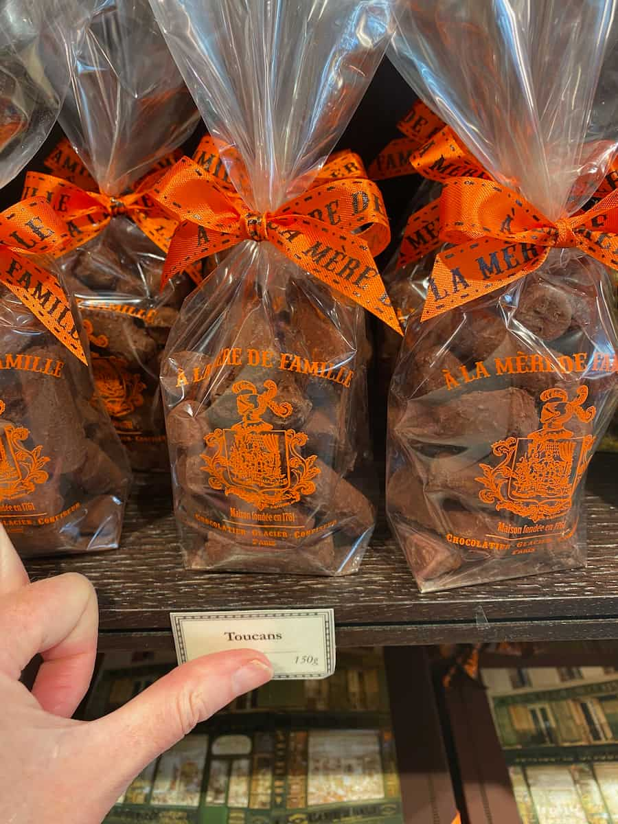 packets of chocolates with orange bows on a shelf