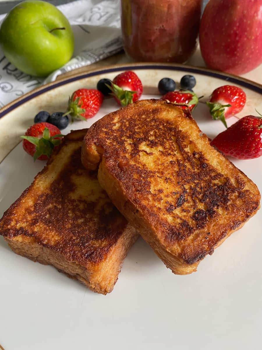 2 golden slices of French toast served with berries, compote but with no topping