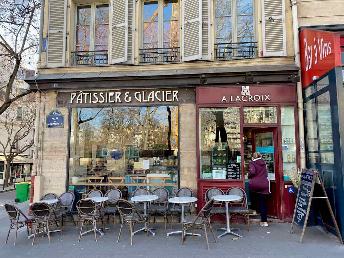 pastry shop and tea room with reflections of notre dame in the window