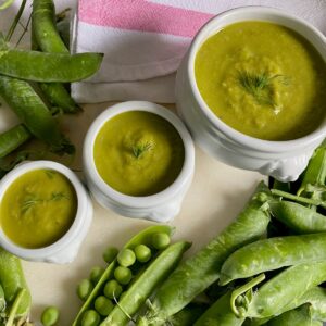 3 bowls of pea soup with fresh peas and pods
