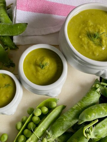 3 bowls of pea soup with fresh peas and pods