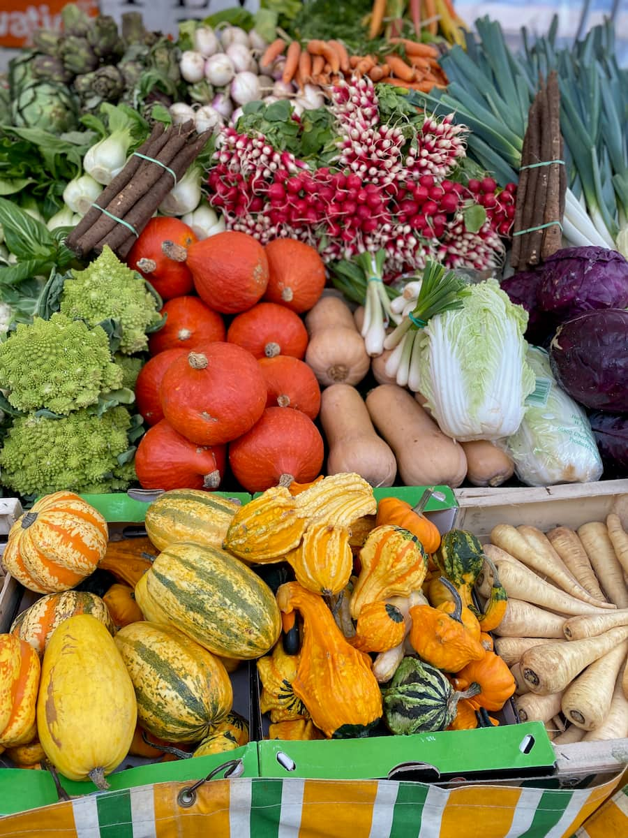 pile of fresh vegetables at the French market, mainly pumpkin and squash