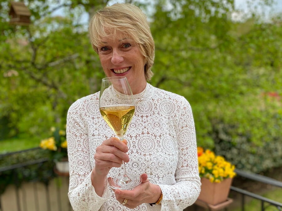 author Jill Colonna in Paris France, holding a glass of Champagne