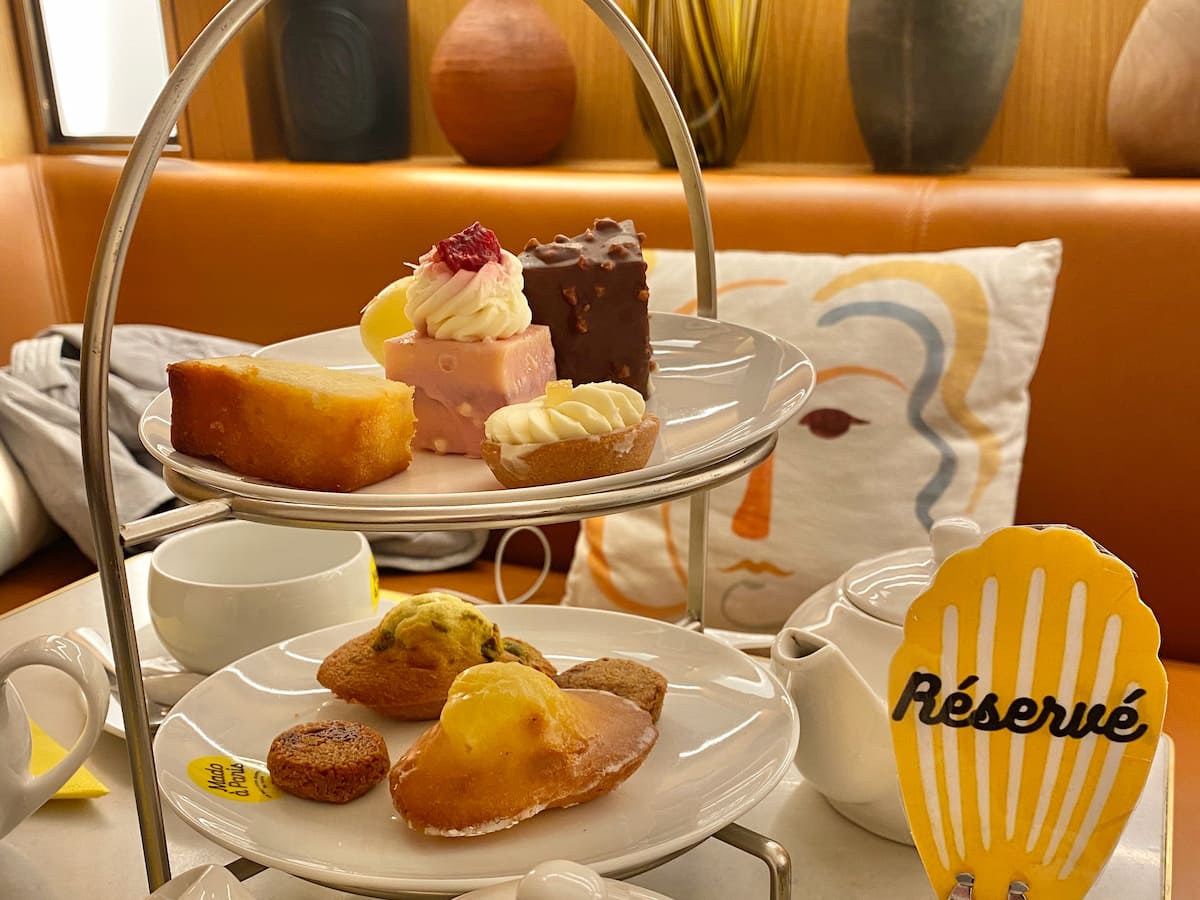 tray of cakes with a reserved sign in French shaped as Madeleine