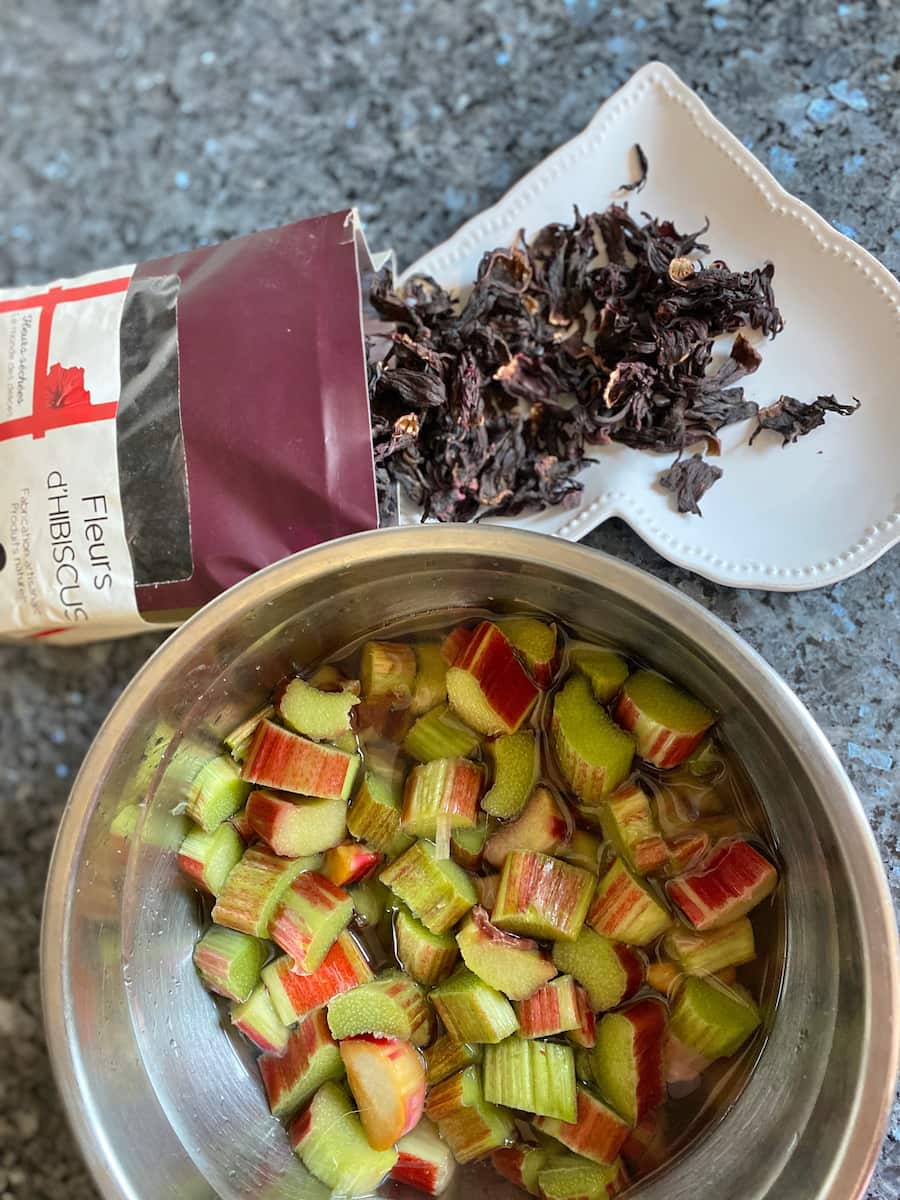 rhubarb pieces macerated in sugar next to dried hibiscus flowers