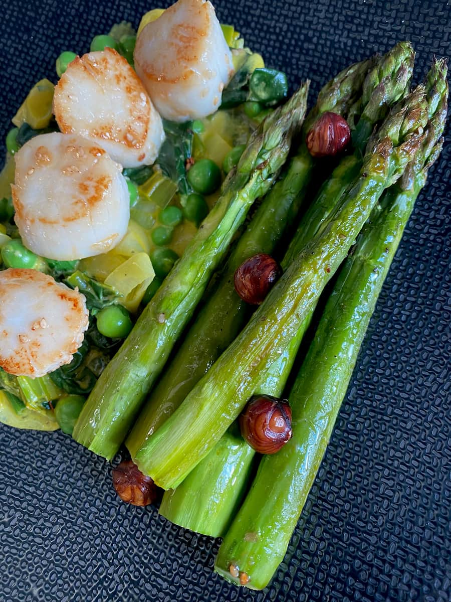 roasted asparagus with hazelnuts, peas and scallops