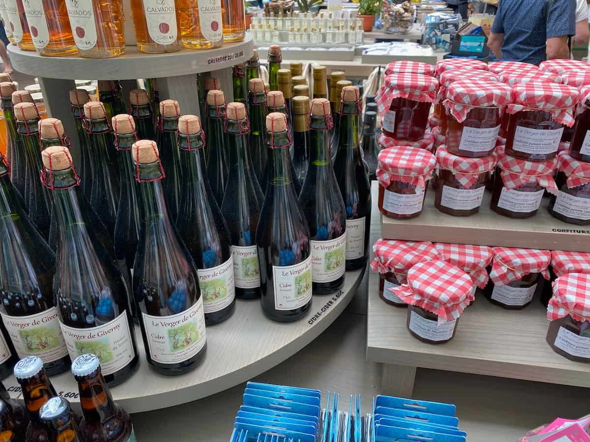 bottles of French cider and pots of artisanal jams in a Giverny shop, Normandy