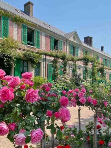 Monet's house and gardens with roses and green shutters