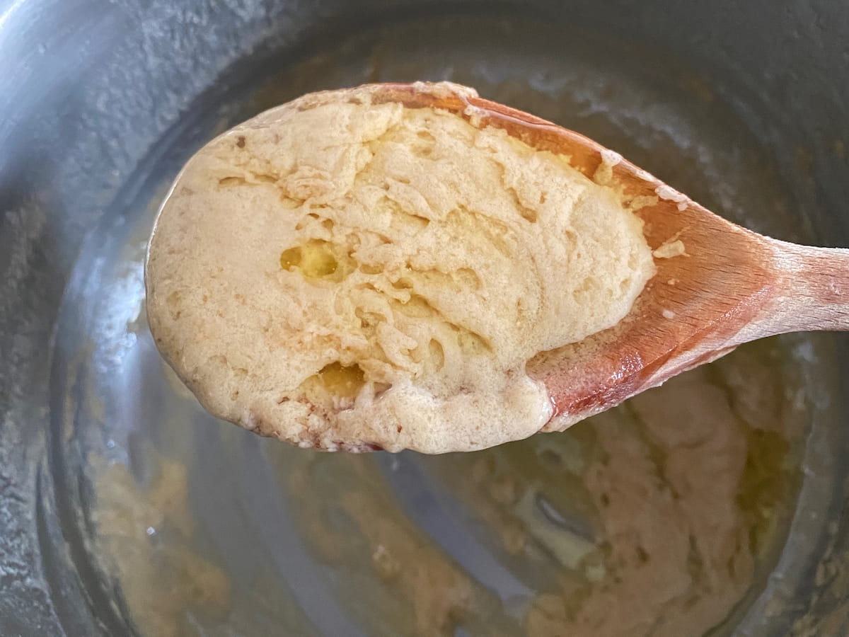 example of when the sauce splits, seeing a thick sauce and bits of melted butter on a spoon