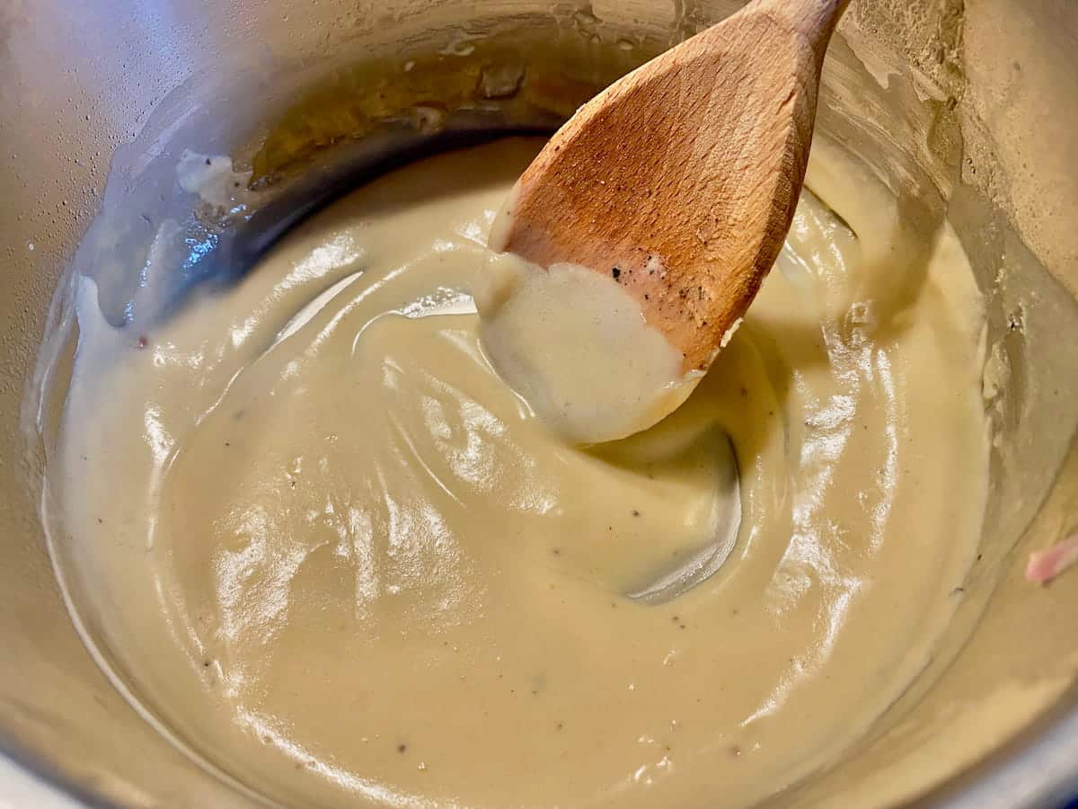 stirring a perfectly smooth and thick French butter sauce or beurre blanc