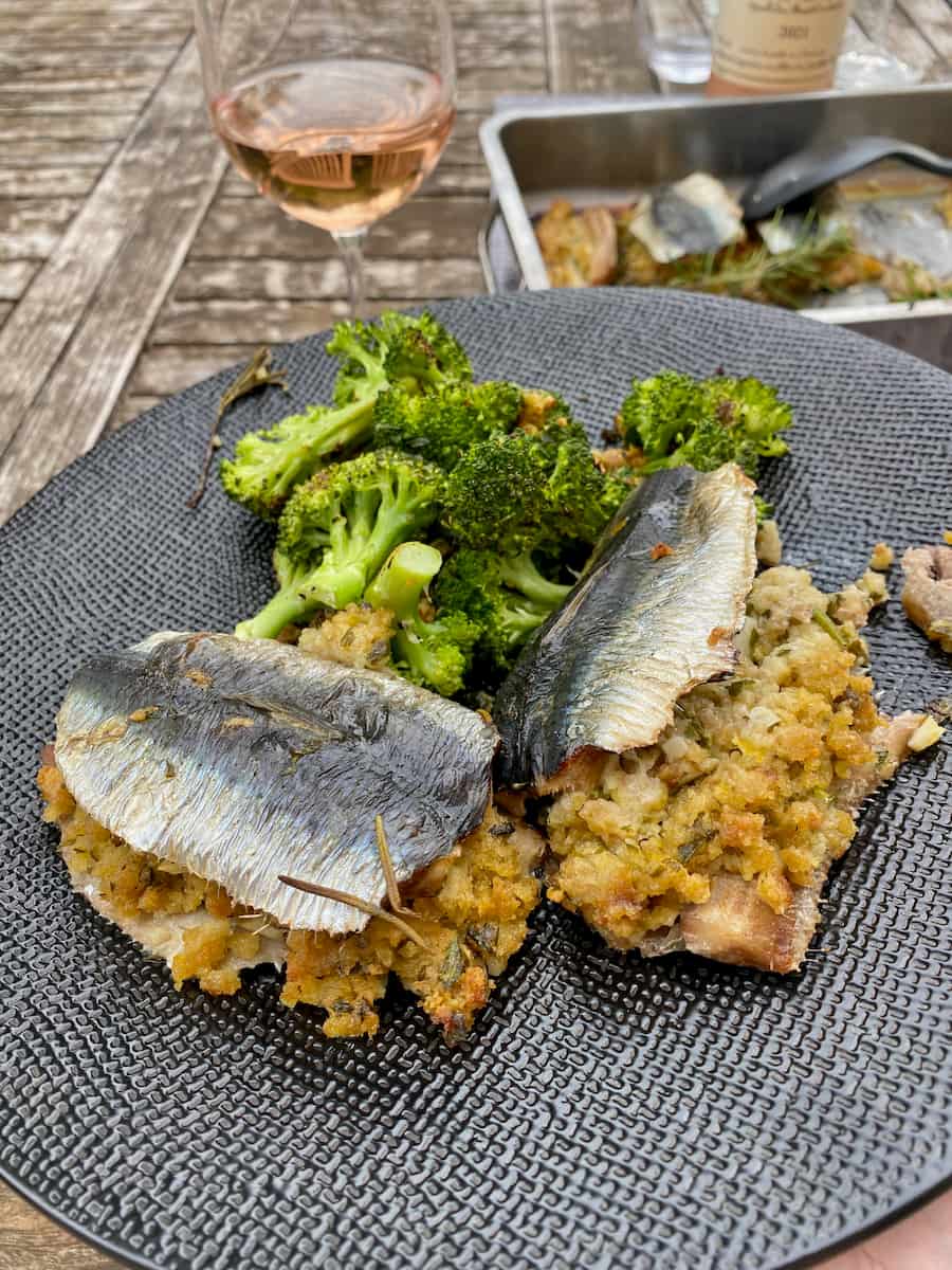 plate with two stuffed roasted sardines with broccoli
