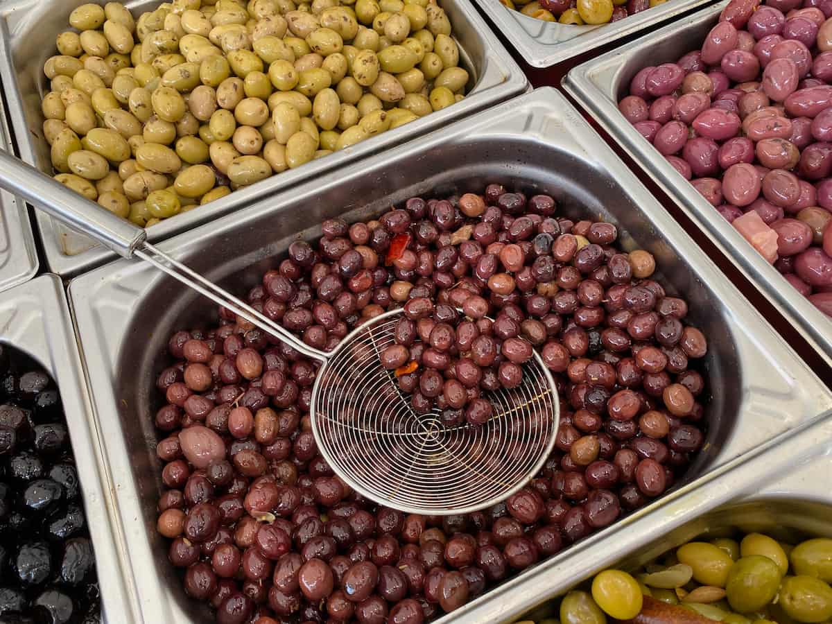 vats of different olives at a French market