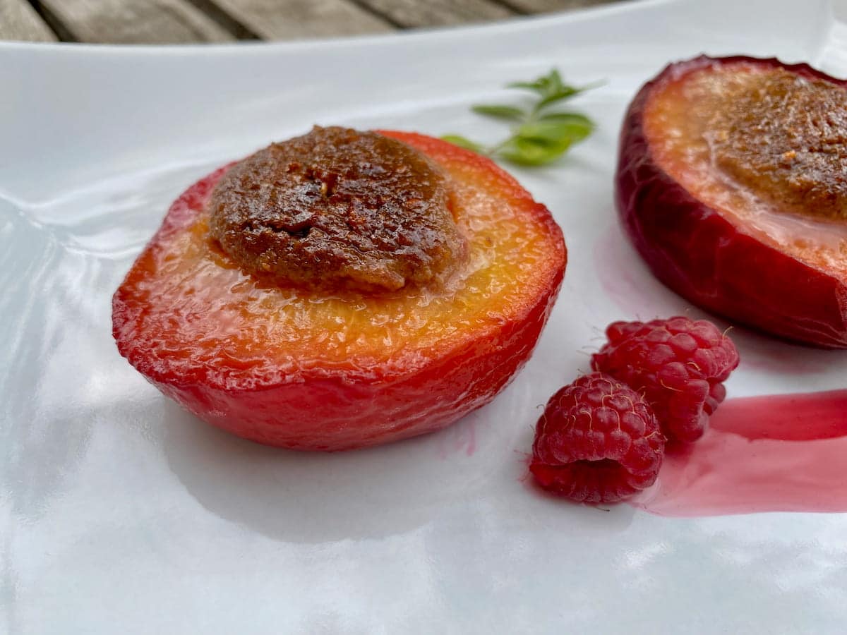 peeled baked peach without the skin on left and unpeeled on the right