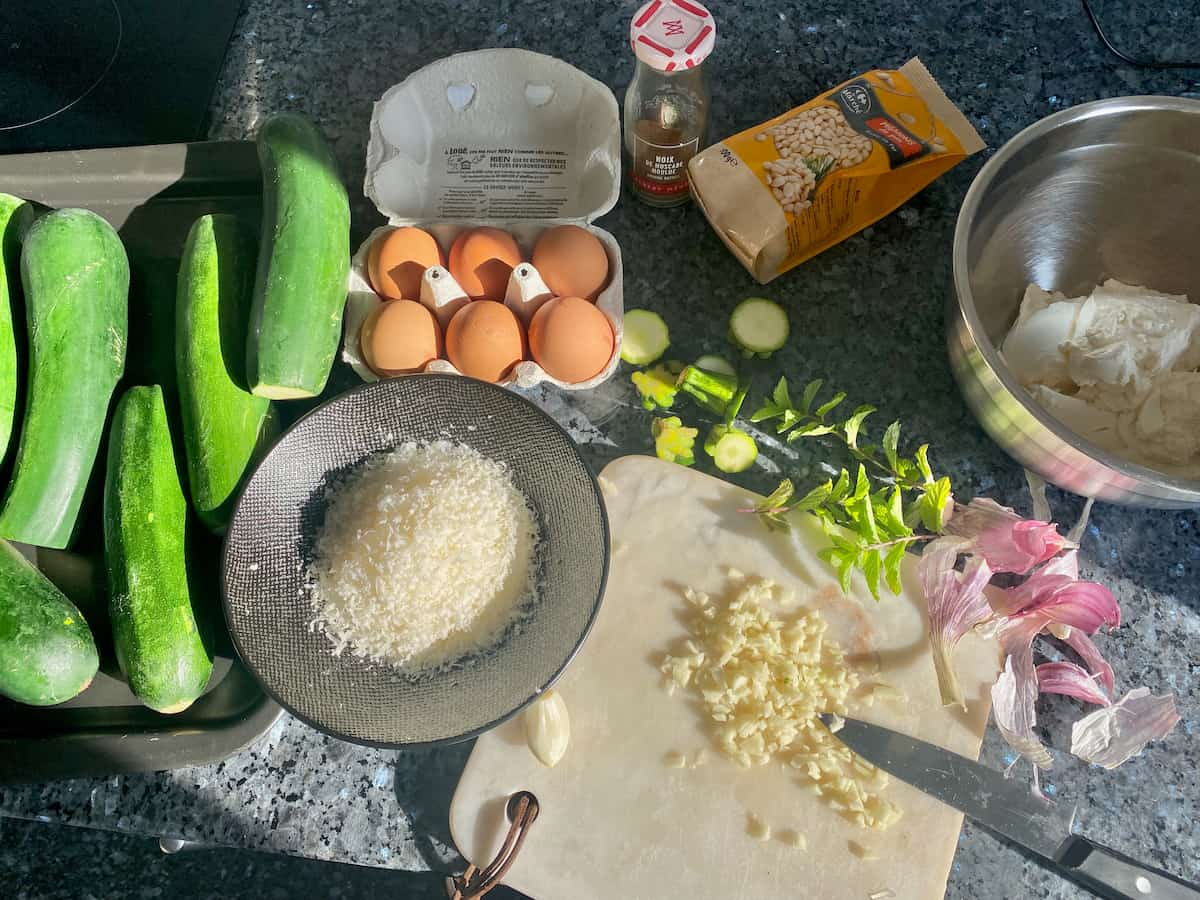 cooked zucchini, grated cheese, chopped garlic, mint, eggs