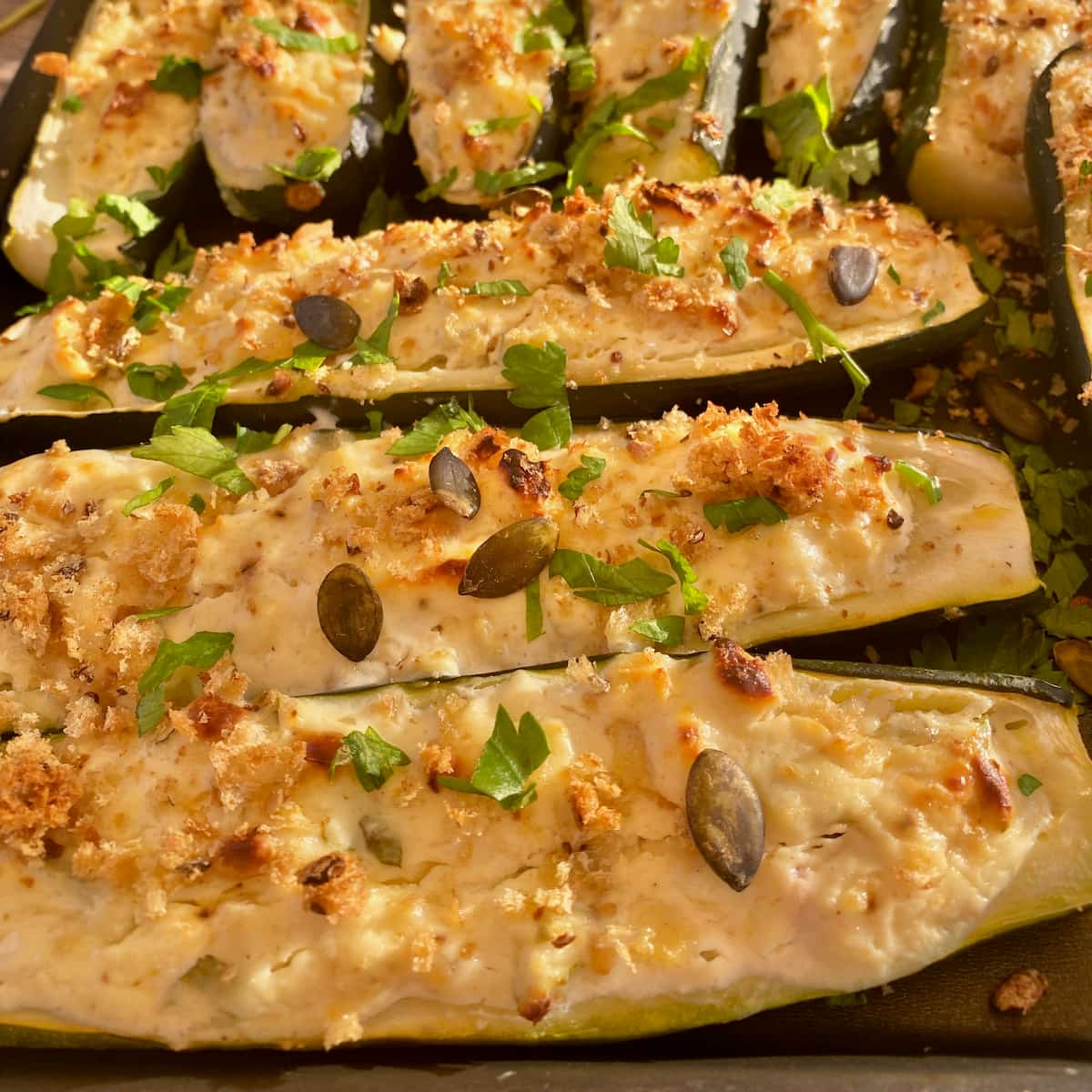 close up of baked courgettes or zucchini boats stuffed with ricotta cheese