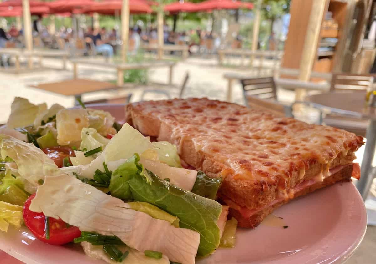 plate of salad with toasted cheese and ham sandwich known as a Croque-Monsieur in France