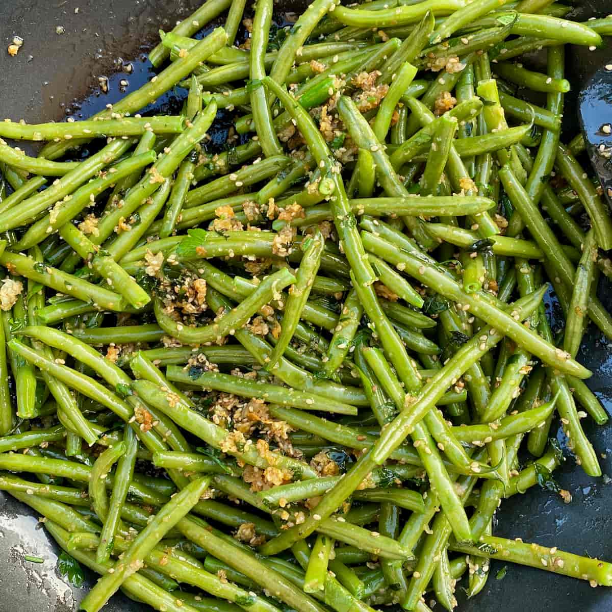 tossed green beans in olive oil, butter, breadcrumbs, garlic and herbs