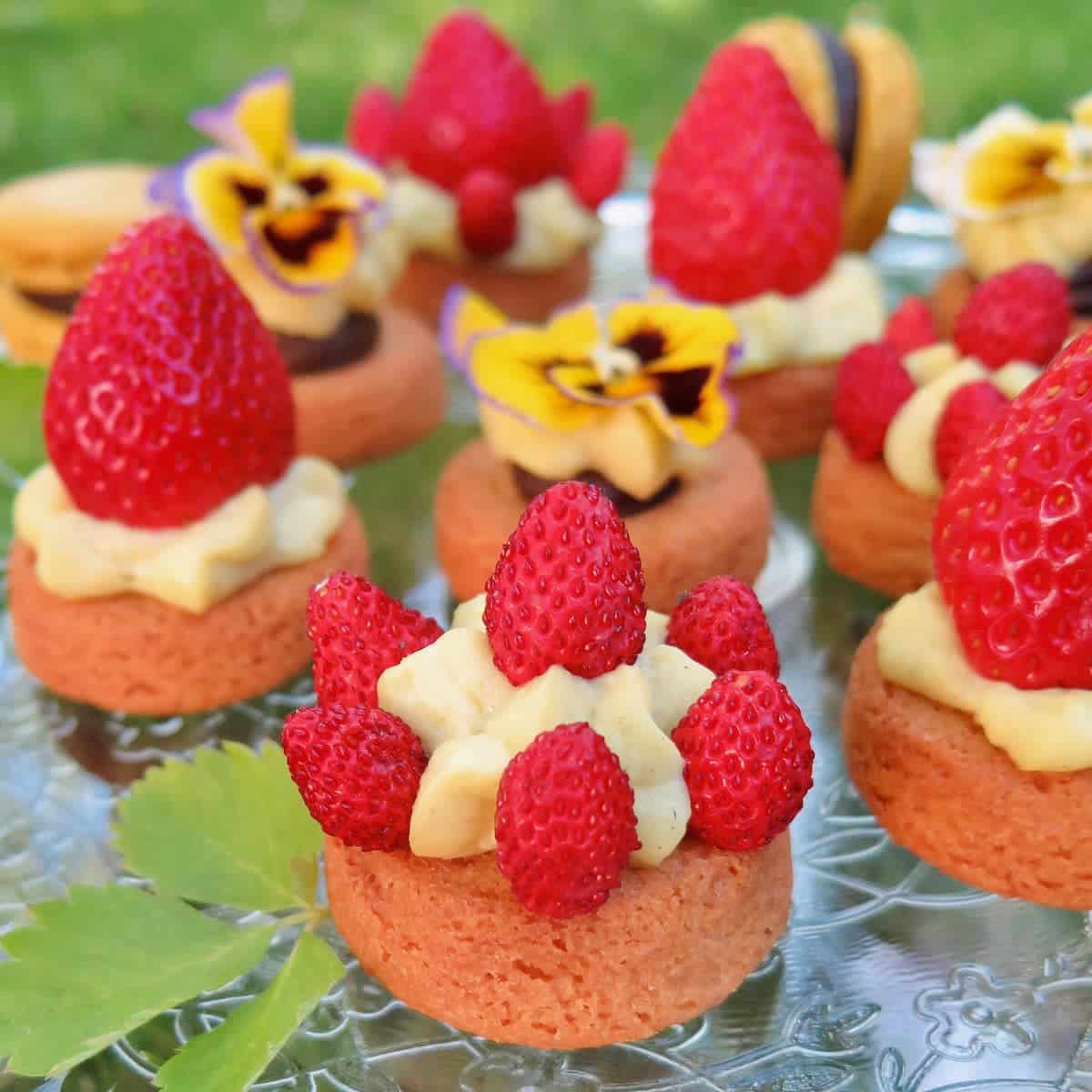 thick salted butter cookies or palets bretons topped with pastry cream and strawberries