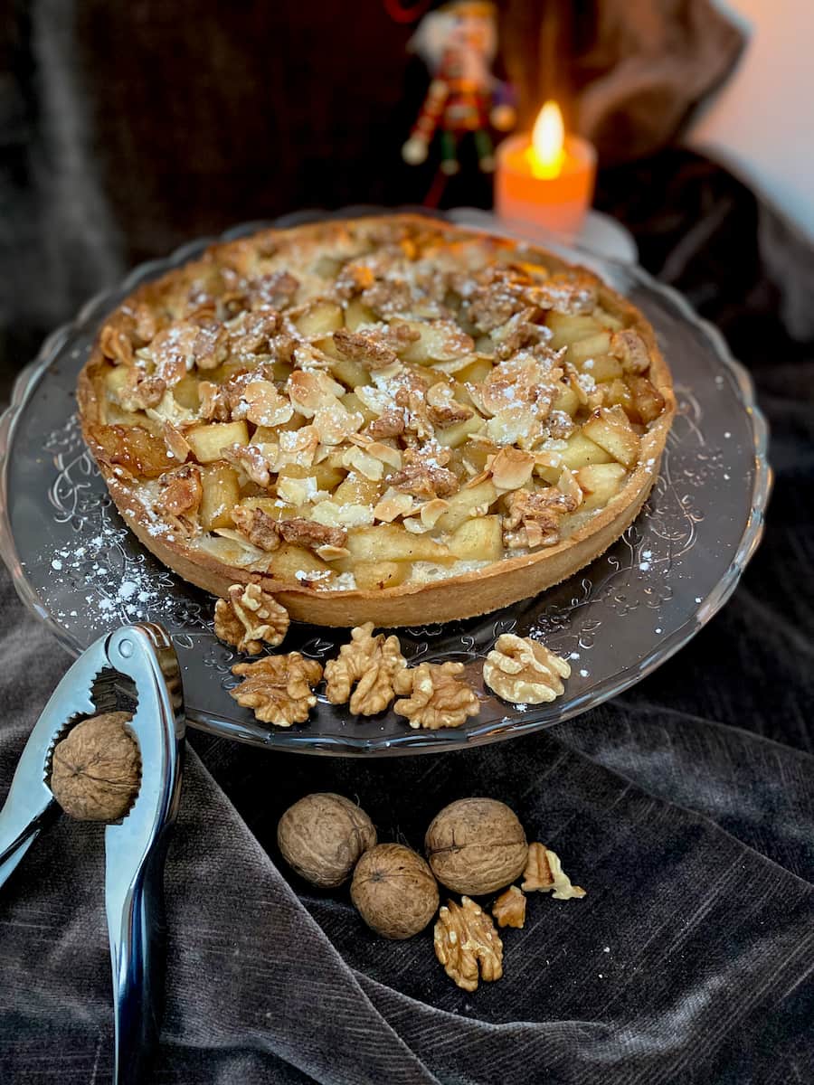chunky apples in a tart topped with crunchy almonds and walnuts