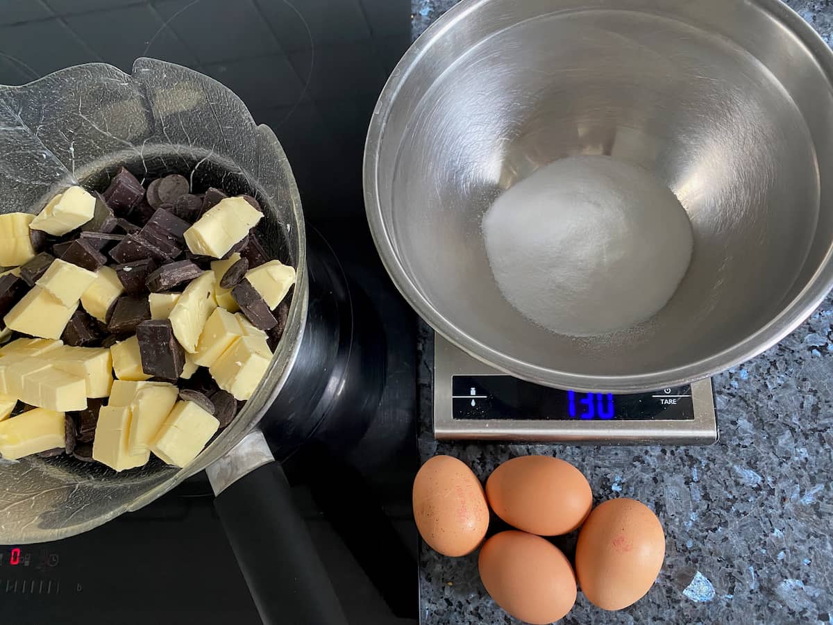 weighing out brownie ingredients, while melting chocolate and butter in a double boiler