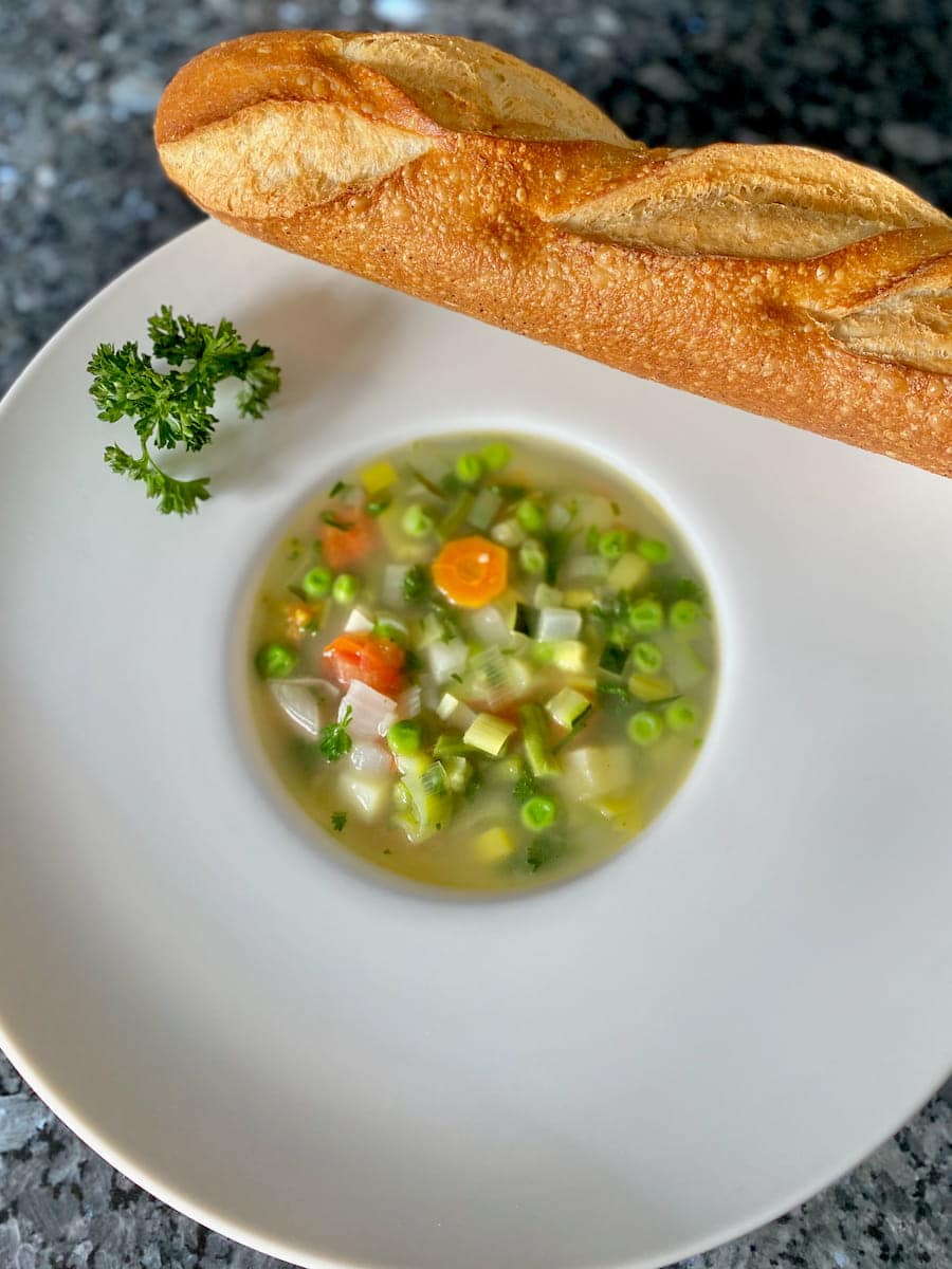 fresh vegetable soup not puréed but served with chunks and no cream with a crusty French baguette