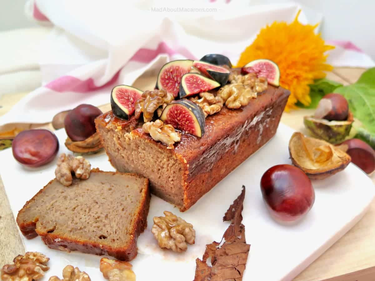 close-up of a moist banana bread topped with toasted walnuts