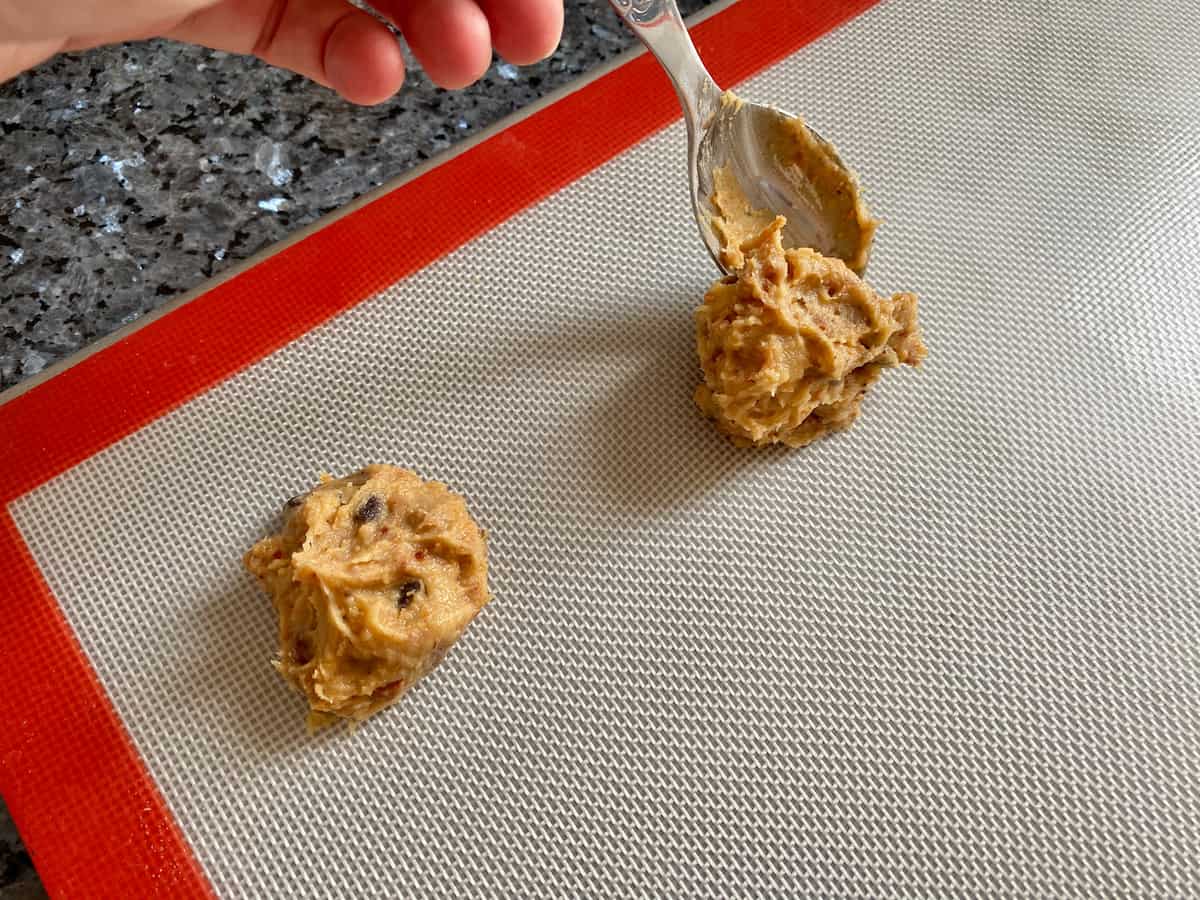 spacing out dough to make peanut butter chocolate chip cookies