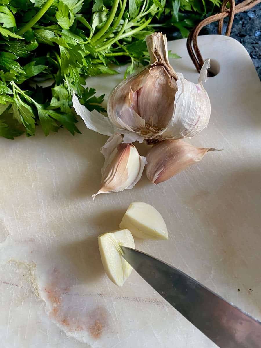 taking out the central vein of a clove of garlic with an office knife