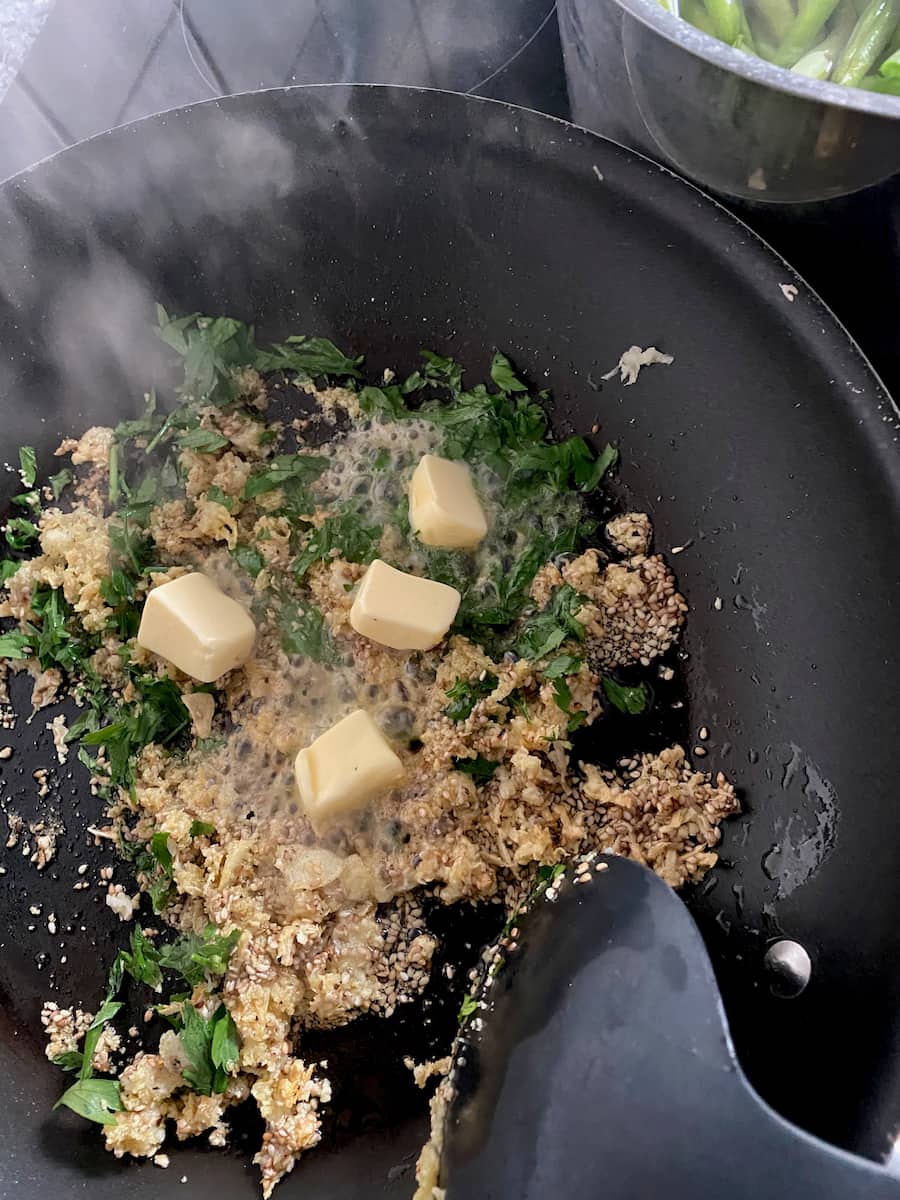 sauté pan with herb mixture and melting butter in the heat