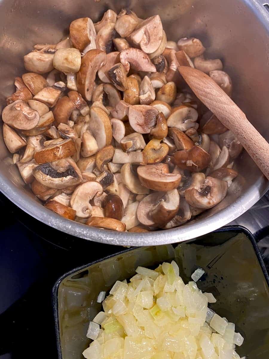 sweating mushrooms in a pan after cooking the chopped onions separately