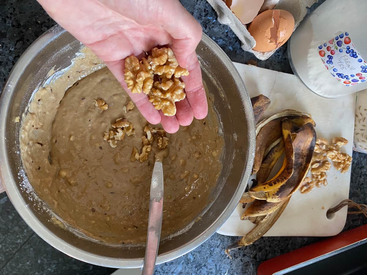 adding walnuts to the banana coffee cake batter