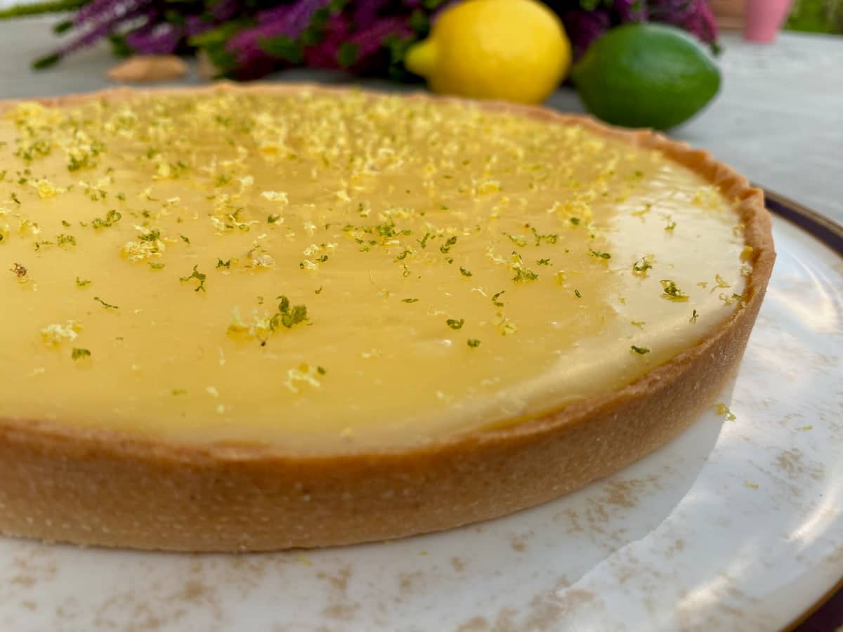 glossy tarte au citron topped with citrus zest