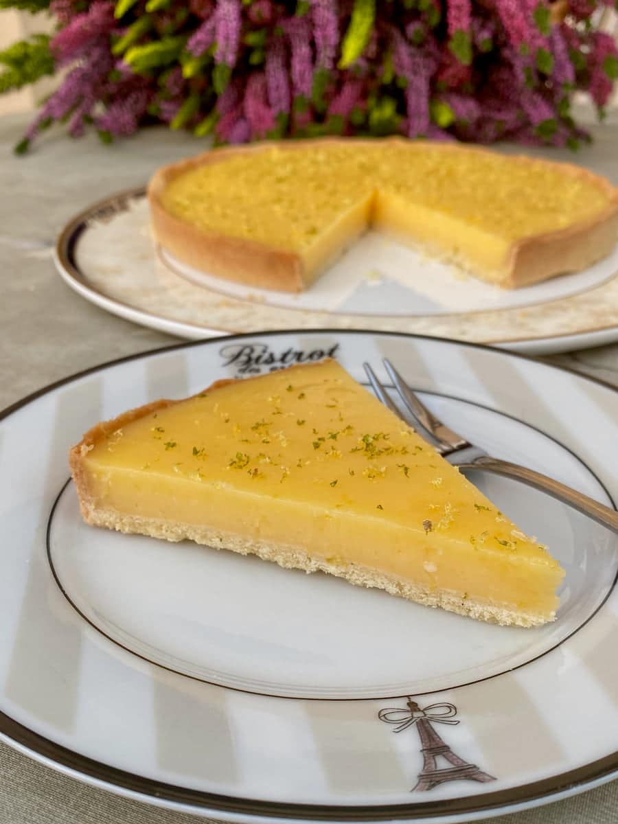 perfect slice of French tarte au citron, topped with lemon and lime zest