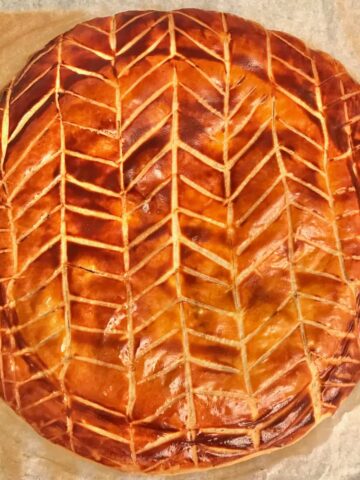 galette des rois golden, glossy puff pastry round with criss-cross pattern