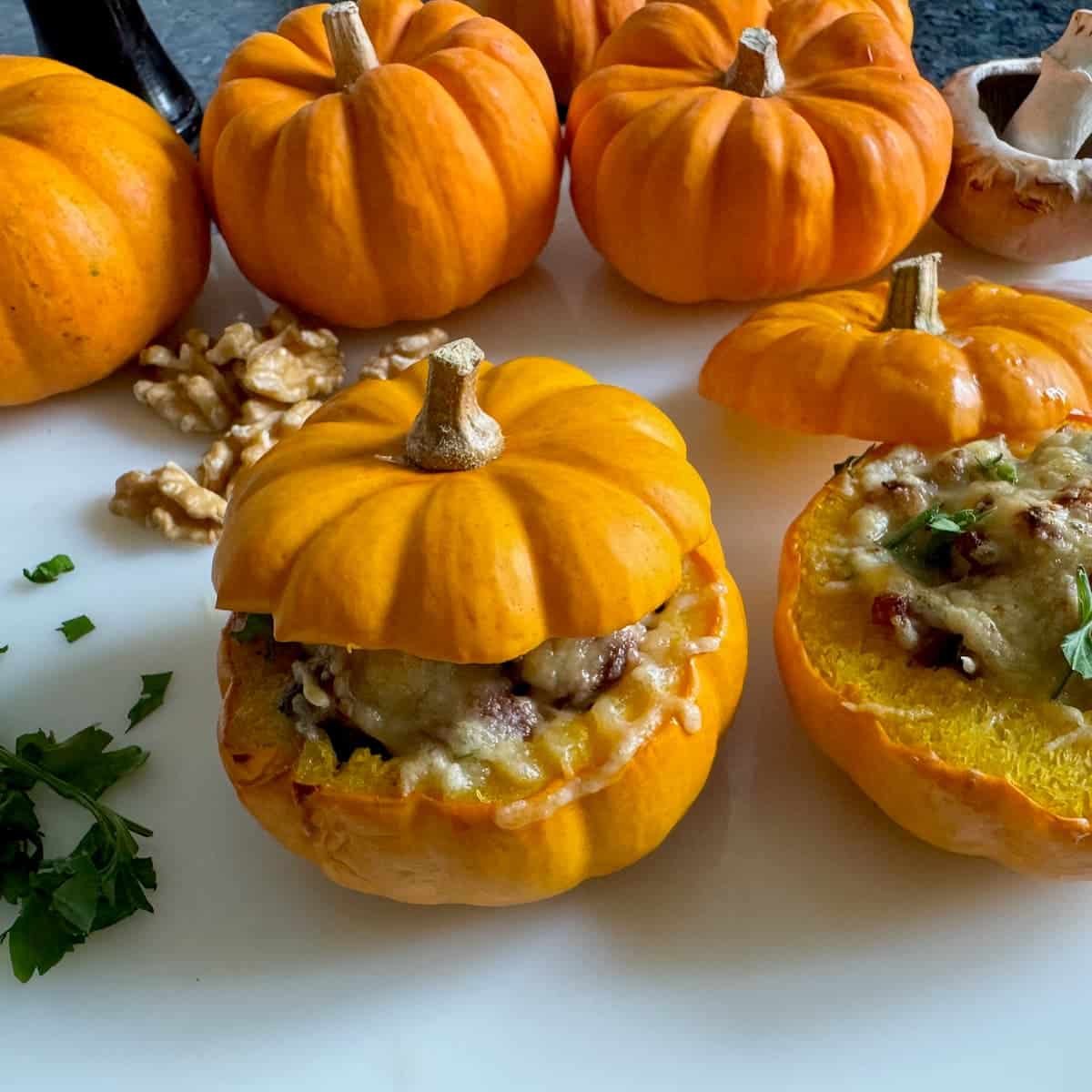 mini orange pumpkins with 2 tiny ones cut open and stuffed