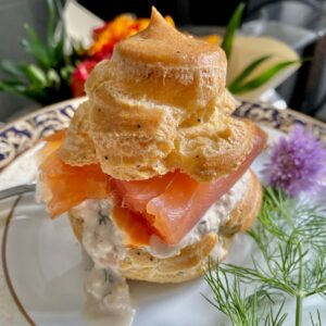 large choux bun filled with smoked salmon and runny cream with apple and dill