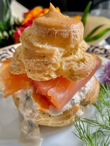 large choux bun filled with smoked salmon and runny cream with apple and dill