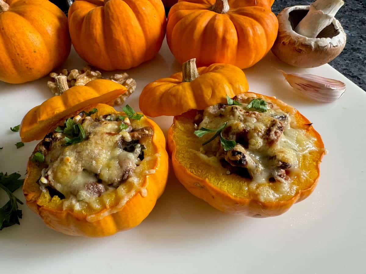 tiny pumpkins split open, cooked and stuffed with mushrooms, nuts, herbs and melted cheese