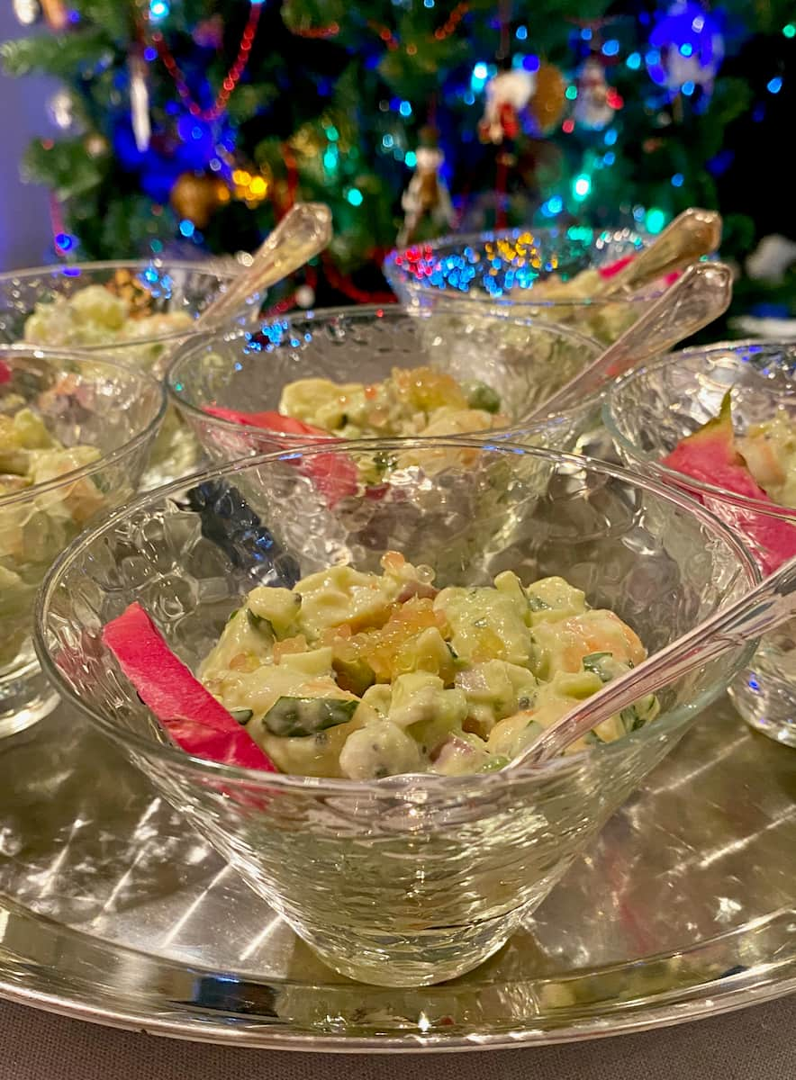 glass dishes with shrimp cocktail garnished with a slice of dragon fruit