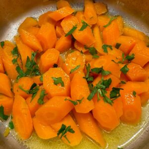 glazed sliced carrots shining with butter