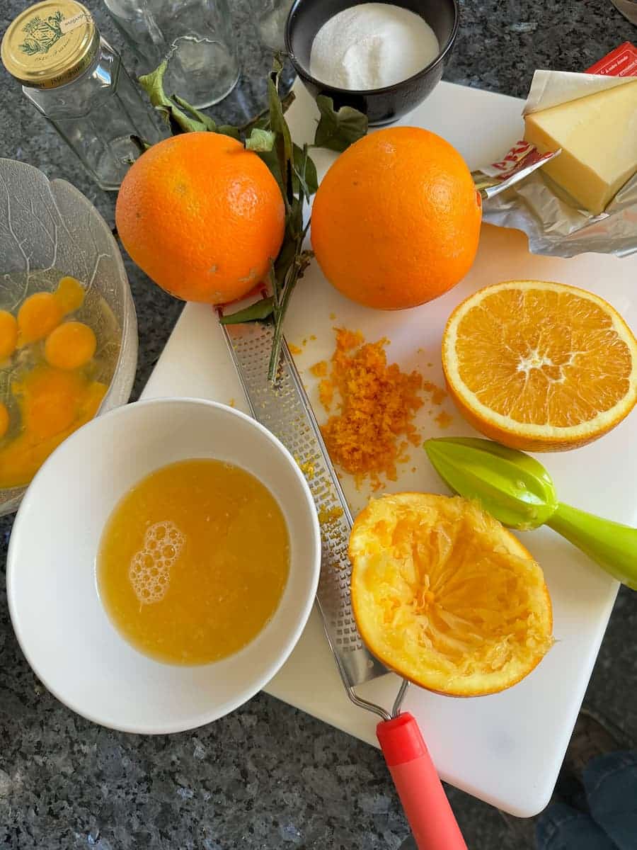 squeezing the juice and zest from fresh oranges