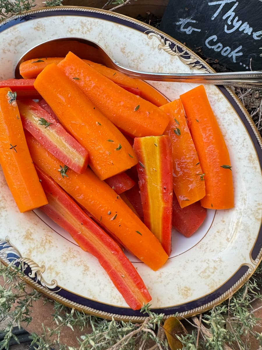 cooked glazed carrots glazed in butter and herbs, cut vertically