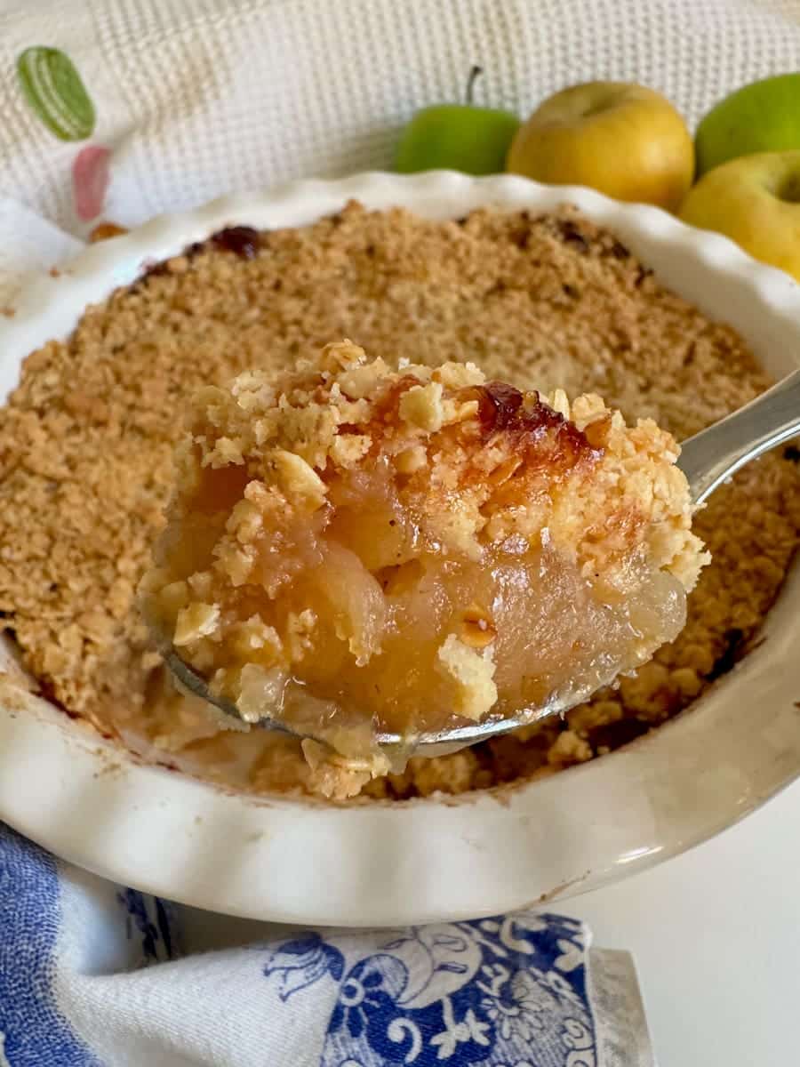 large spoonful of toasted apple crumble with a crispy oat topping