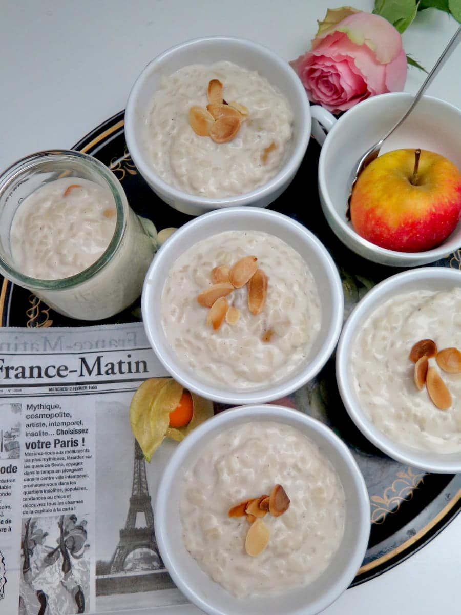 pots of creamy almond milk rice pudding topped with toasted almonds